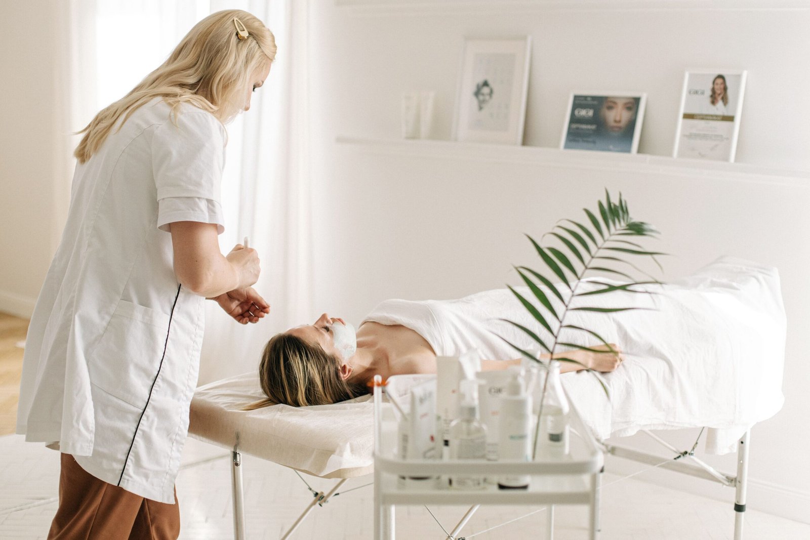 A serene spa setting featuring a facial treatment with a professional beautician, highlighting relaxation and skincare.